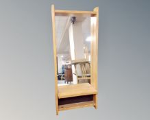 A continental pine framed mirror with shelf,