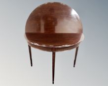 A mahogany demilune turnover top hall table.
