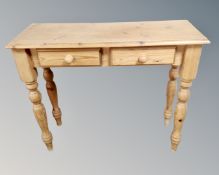 A pine hall table fitted with two drawers.