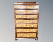 A 19th century Biedermeier burr walnut and ebonised seven drawer chest.