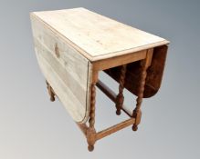 A 19th century oak drop leaf table,