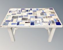 An early 20th century painted pine tiled topped table,