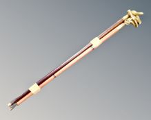 A bundle of four brass handled walking canes.