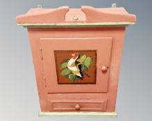A continental painted pine single door wall cabinet fitted with a drawer.