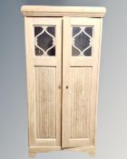 A continental blond oak double door bookcase.