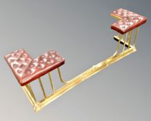 A brass Chesterfield buttoned oxblood leather club fender (width 157cm)