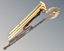 A reproduction halberd, two clubs and three walking sticks.