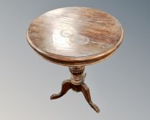 A carved tripod occasional table on paw feet,