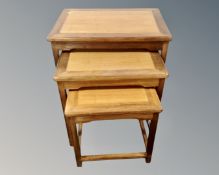 A large nest of three hardwood tables.