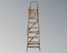 A folding wooden stepladder.
