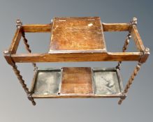 An Edwardian oak umbrella stand on barleytwist support.