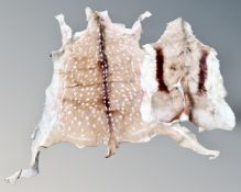 A deerskin rug together with a further example.