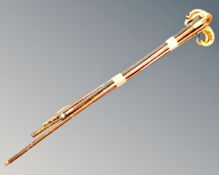 A bundle of six walking sticks with wooden and horn handles.