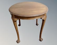 A mahogany circular occasional table, on claw and ball feet.