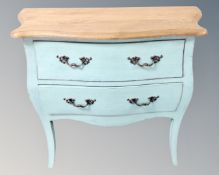 A painted oak bombe two drawer chest.