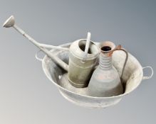 A galvanized twin handled wash tub together with a jug and a watering can.
