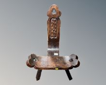 A rustic tripod stool.