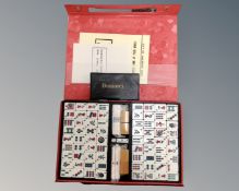 A Mahjong set together with a 28-piece domino set.