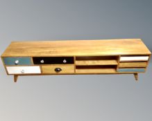 A contemporary teak low entertainment stand, fitted with shelves and drawers.