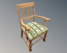 An early 20th century oak open armchair