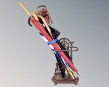 An antique style cast iron stick stand together with a collection of parasols,