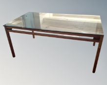 A Danish smoked glass topped coffee table on teak legs