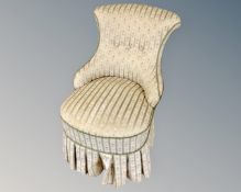 A 20th century nursing chair in striped fabric
