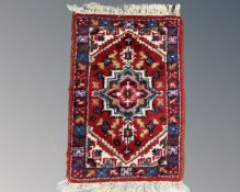 A small Iranian hearth rug 64 cm x 40 cm