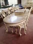 An impressive 20th century Venetian style oval extending table, with four leaves, on scroll legs,
