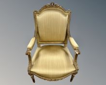 A cream and gilt French style open armchair