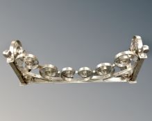 A chrome fire grate, width 54cm.