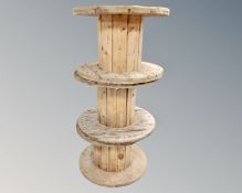Three wooden cable spools,