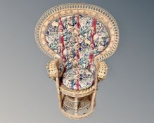 A 20th century wicker peacock armchair.