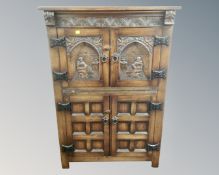 A good quality carved oak double door cabinet.