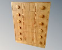 A Danish pine seven drawer chest