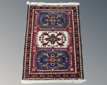 A Caucasian rug on red and blue ground,