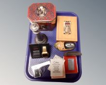 A tray containing boxed Colibri lighter, table lighter in the form of a clog,