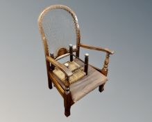 A 20th century beechwood armchair together with a rush seated stool.