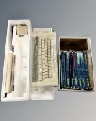 A vintage Acorn Electron computer and keyboard in original packaging with introductory cassettes