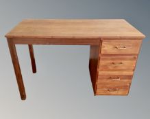 A 20th century teak single pedestal desk