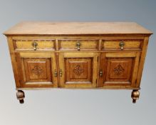 An Edwardian oak triple door sideboard.