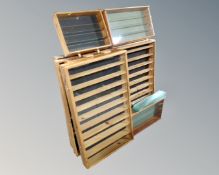 Nine wall mountable display cabinets with shelves.