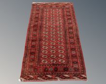An Afghan Tekke rug on red ground,