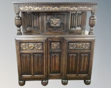 A 20th century carved oak buffet sideboard.