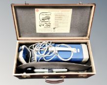 A vintage Hoover vacuum cleaner in case.