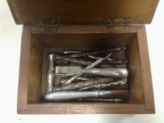 An antique mahogany box containing nut crackers