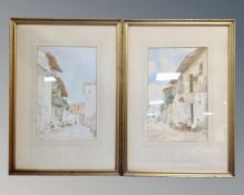 A pair of watercolours depicting figures in a rural village in gilt frames