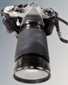 A Pentax ME camera with Chinon zoom MC 35-200mm lens