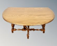 An Ercol drop leaf coffee table on turned legs
