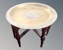 A Continental brass topped folding table